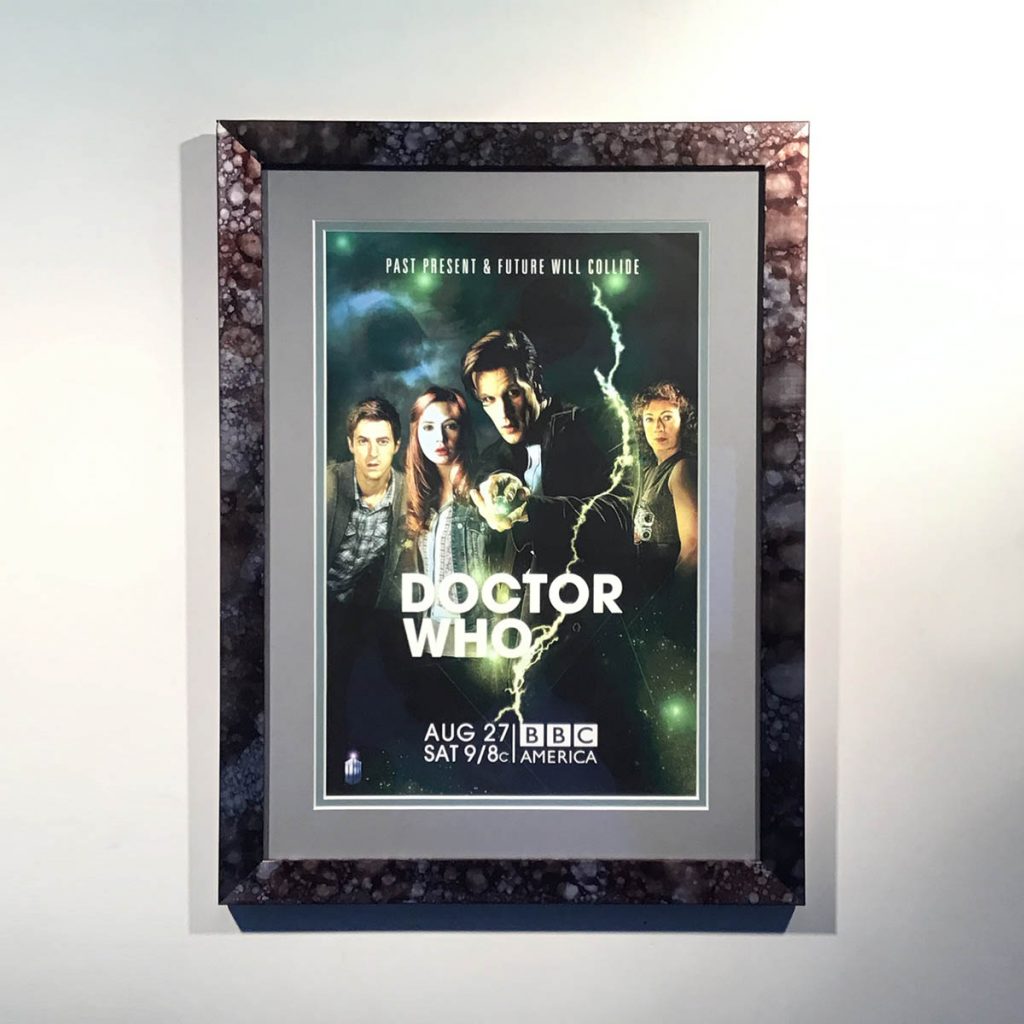A Doctor Who poster double mounted in a smooth metallic textured frame