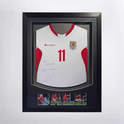 A stretched Christian Bale signed shirt. The name "Bale" is made from photos of him. It's on a dark grey mount in a black poly frame.